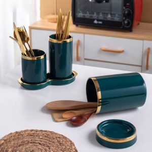 ceramic utensil holder or planter with a gold rim and base